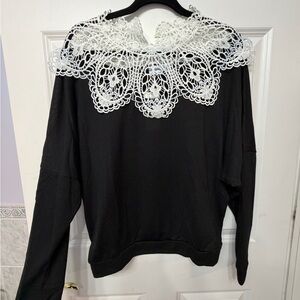 Chic Black Blouse with Intricate White Lace Collar